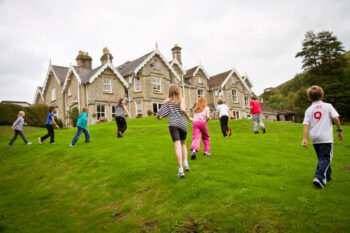 Children playing on the lawn at Dunfield House