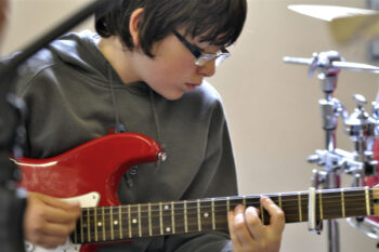 Boy playing guitar at Dunfield House