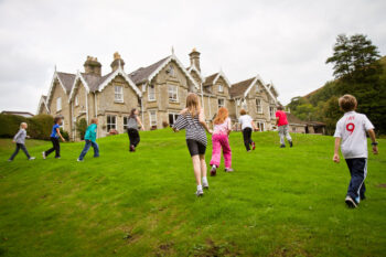 Children playing on the lawn at Dunfield House